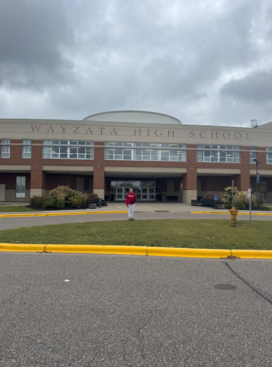 Ruby Ackerly standing outside of Wayzata High School